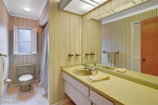 bathroom with crown molding, vanity, and toilet