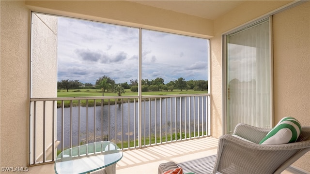 sunroom / solarium with a water view