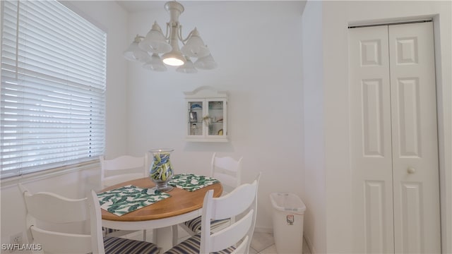 tiled dining space featuring a notable chandelier