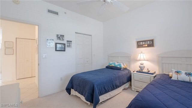 carpeted bedroom with ceiling fan and a closet