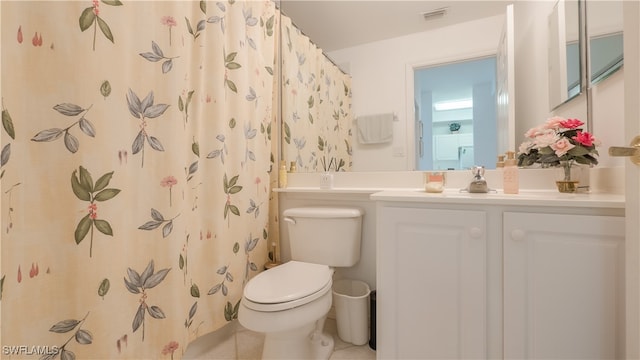 bathroom with walk in shower, vanity, toilet, and tile patterned floors