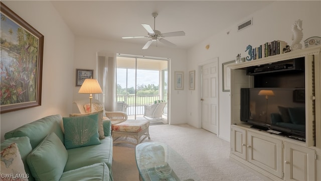 carpeted living room with ceiling fan