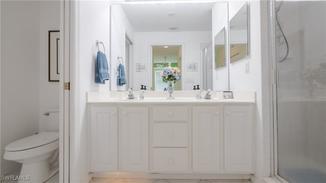 bathroom with vanity, toilet, tile patterned floors, and an enclosed shower