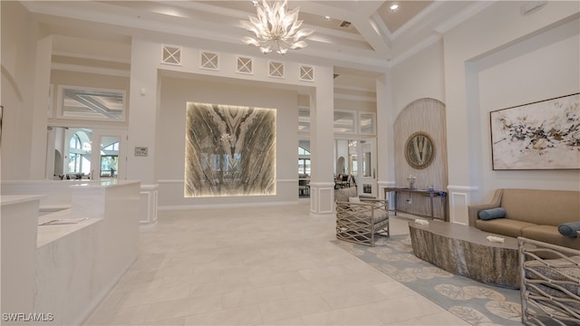 interior space with beamed ceiling, coffered ceiling, a high ceiling, an inviting chandelier, and ornate columns