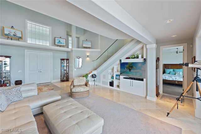 living room with ceiling fan and light tile patterned floors