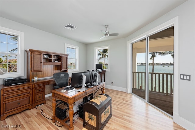 office with ceiling fan, light wood-type flooring, and a healthy amount of sunlight