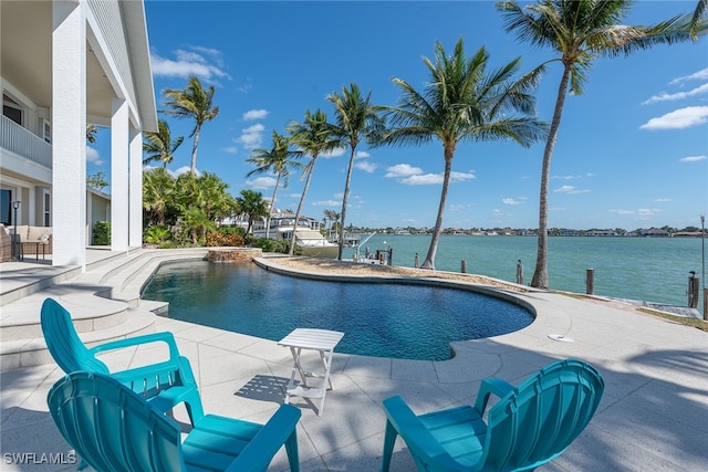 view of pool with a water view and a patio area