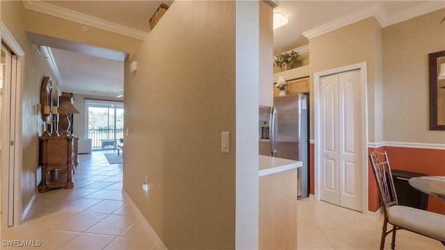 hall featuring crown molding and light tile patterned flooring