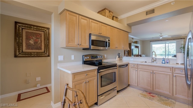 kitchen with ceiling fan, sink, light tile patterned floors, stainless steel appliances, and crown molding