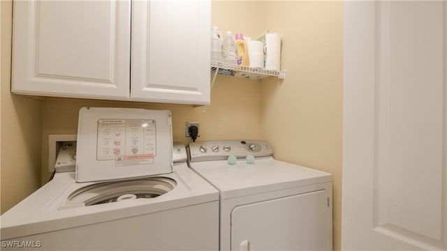 laundry room with cabinets and washer and dryer