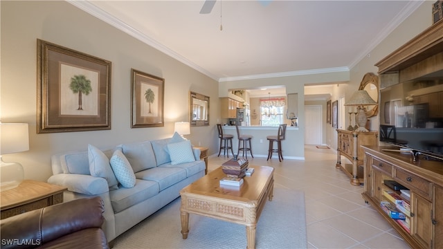 living room featuring ceiling fan, light tile patterned flooring, and ornamental molding