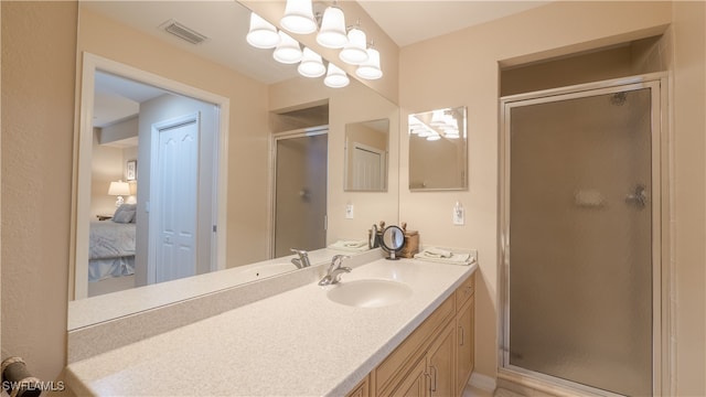 bathroom featuring vanity and a shower with shower door