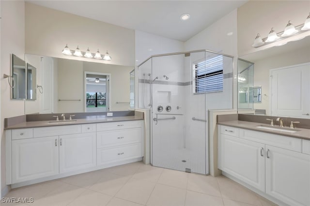 bathroom featuring walk in shower, vanity, and tile patterned floors