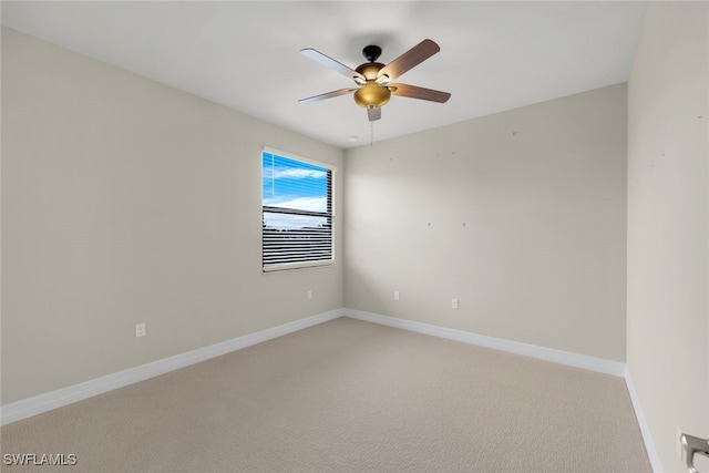 empty room featuring ceiling fan and carpet flooring