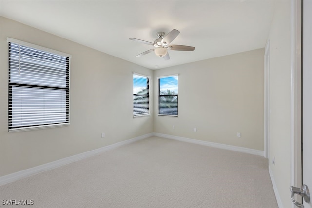 empty room featuring ceiling fan and carpet flooring