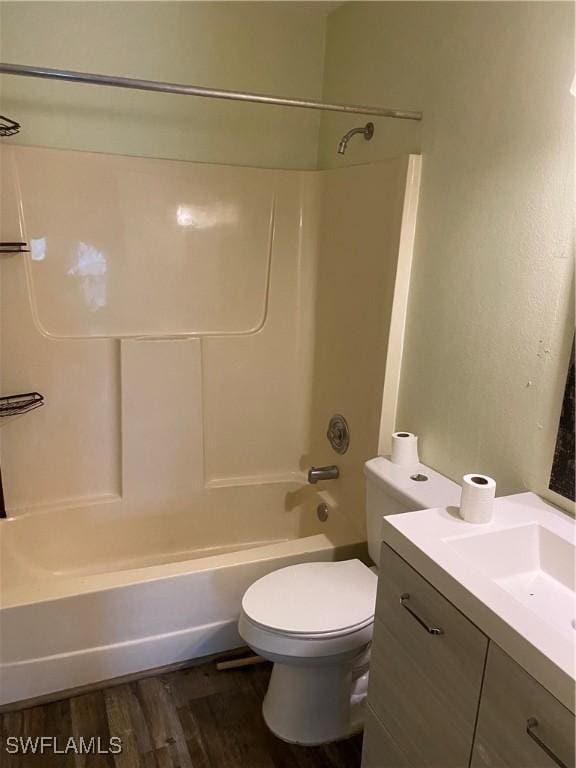 full bathroom featuring vanity, hardwood / wood-style flooring, toilet, and shower / washtub combination