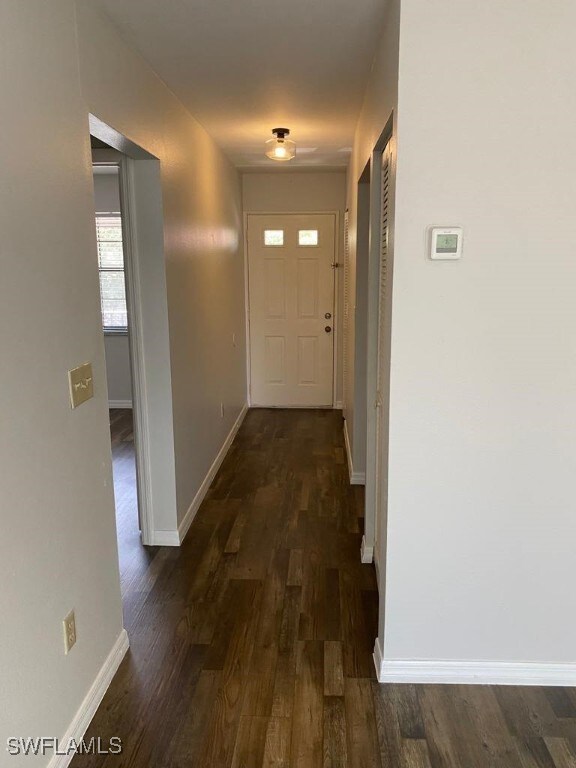 corridor featuring dark wood-type flooring