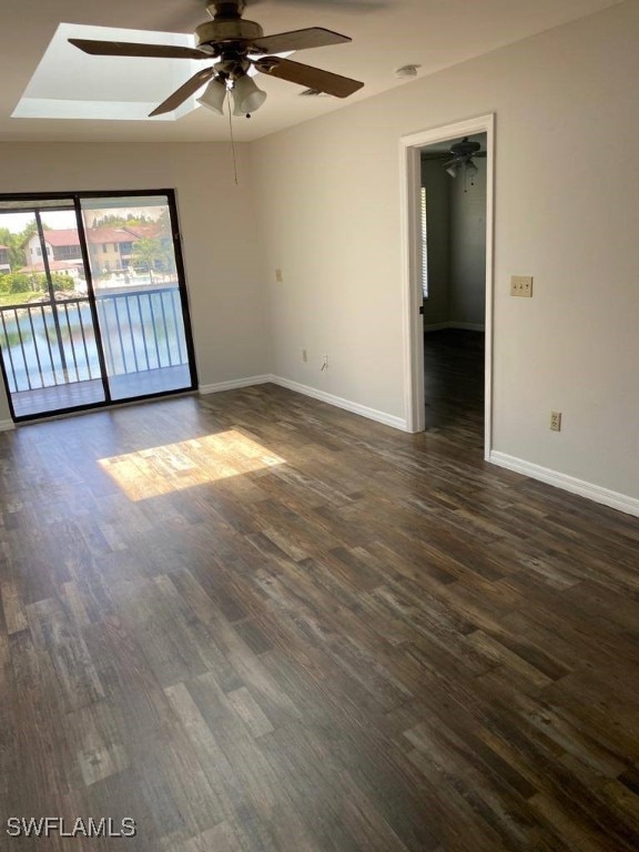 empty room with ceiling fan and dark hardwood / wood-style flooring