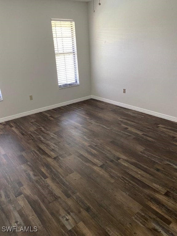 spare room with dark wood-type flooring