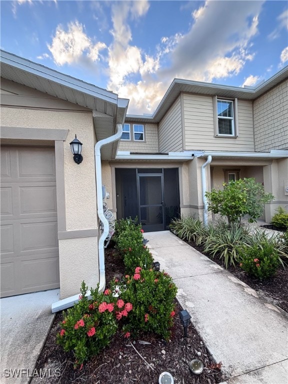 doorway to property with a garage