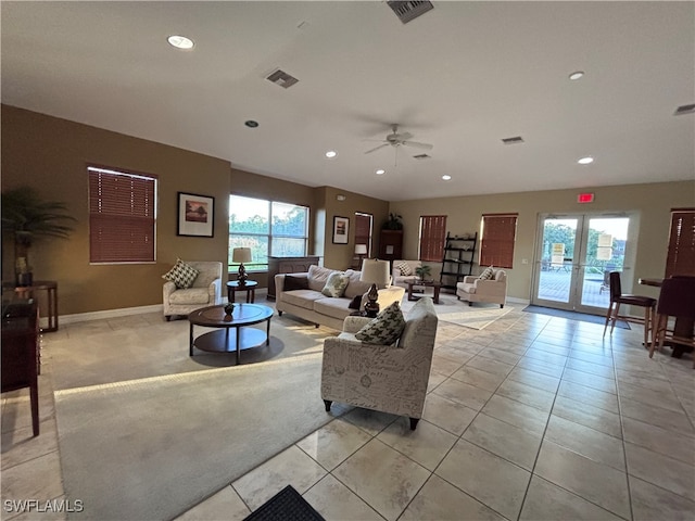 living room featuring ceiling fan, light tile patterned floors, french doors, and a wealth of natural light