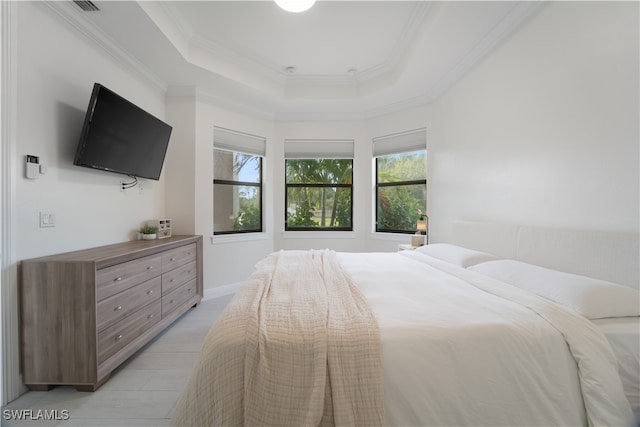 bedroom featuring ornamental molding and a tray ceiling