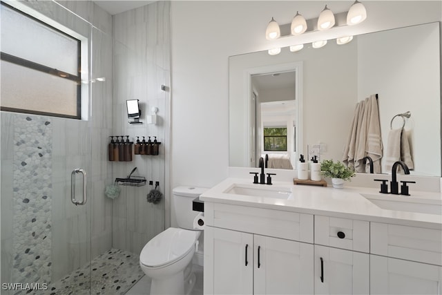 bathroom with walk in shower, vanity, and toilet