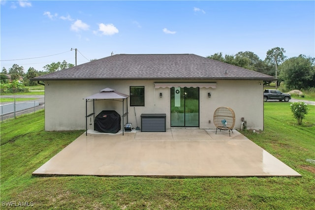 back of house featuring a patio, a gazebo, and a yard