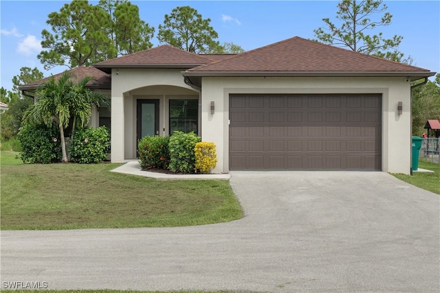 ranch-style home with a garage and a front lawn