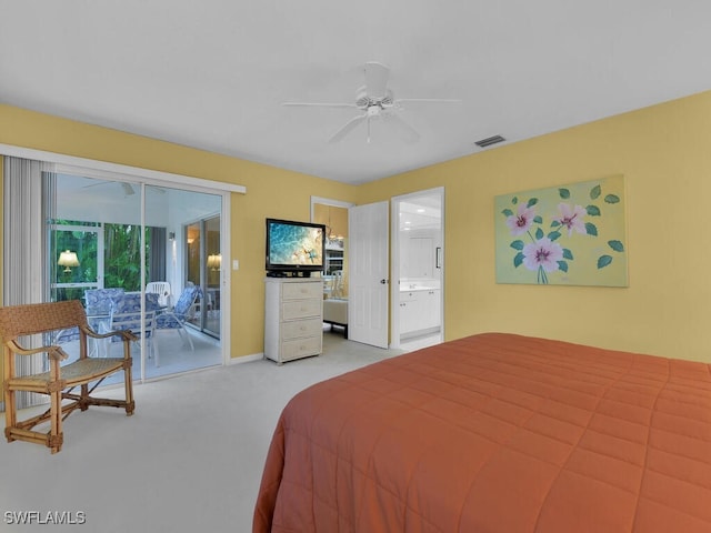 carpeted bedroom featuring access to exterior, ensuite bath, and ceiling fan