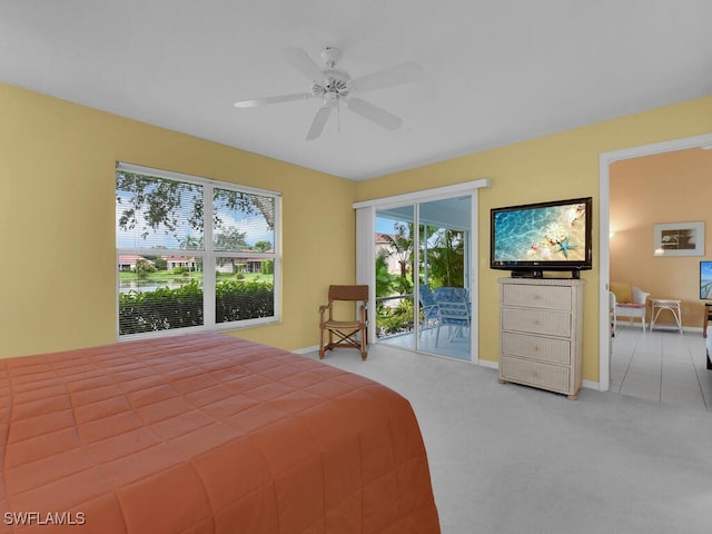 bedroom with access to outside, carpet flooring, multiple windows, and ceiling fan