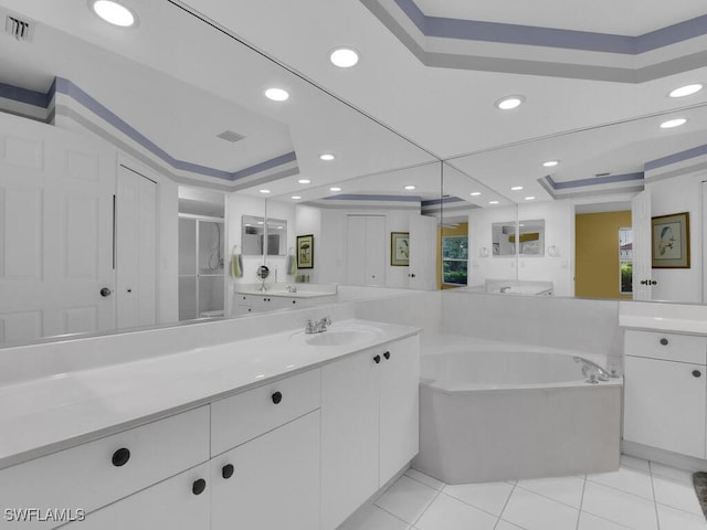 bathroom with vanity, a raised ceiling, tile patterned flooring, and separate shower and tub