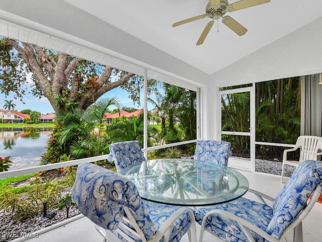 sunroom featuring ceiling fan, lofted ceiling, and a water view