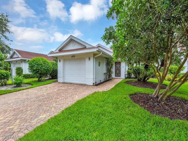 ranch-style home with a front yard and a garage