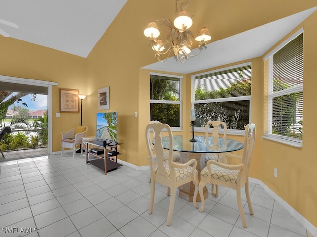 dining space with light tile patterned flooring, plenty of natural light, and an inviting chandelier