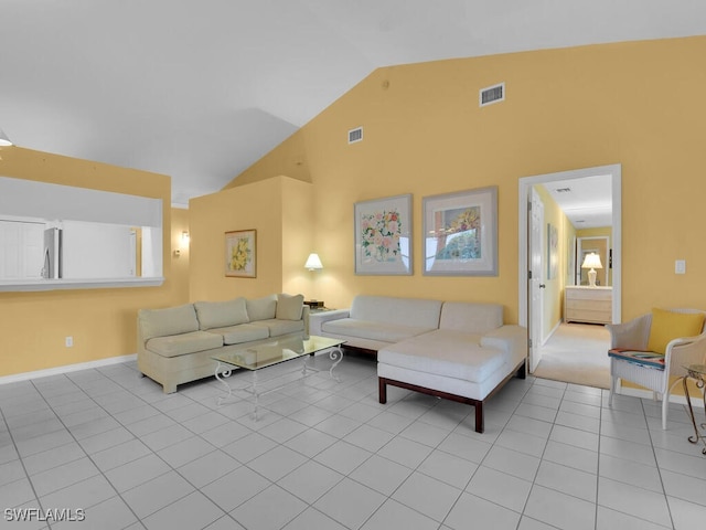 tiled living room featuring high vaulted ceiling