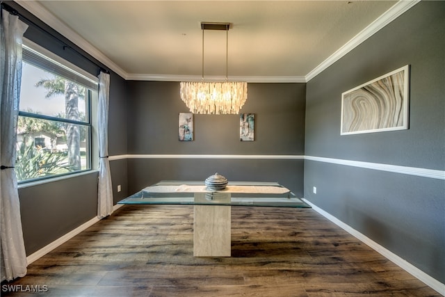 unfurnished dining area featuring crown molding, dark hardwood / wood-style floors, and a chandelier