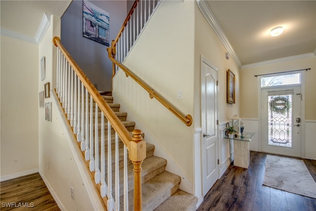 entryway with dark hardwood / wood-style floors and ornamental molding