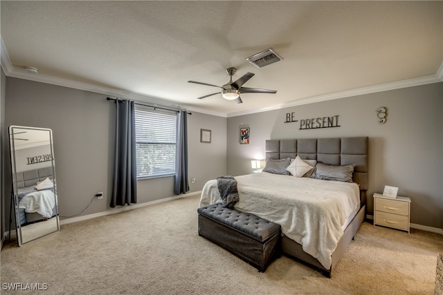 carpeted bedroom featuring ceiling fan and ornamental molding