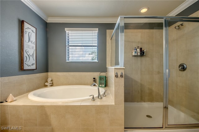 bathroom with ornamental molding and separate shower and tub