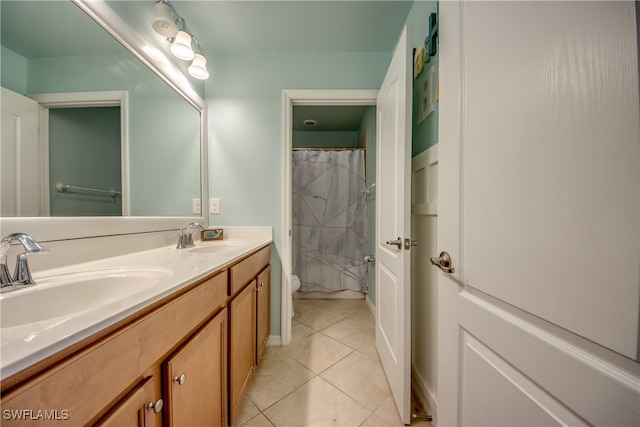 bathroom with tile patterned flooring, curtained shower, vanity, and toilet