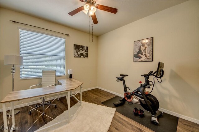 home office with wood finished floors, a ceiling fan, and baseboards