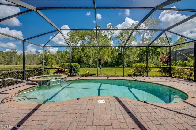 view of pool featuring a patio, glass enclosure, and an in ground hot tub