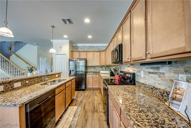 kitchen featuring pendant lighting, sink, light hardwood / wood-style flooring, black appliances, and crown molding