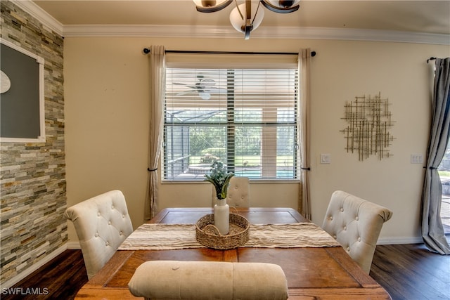 dining space with ornamental molding, dark wood-type flooring, and a wealth of natural light