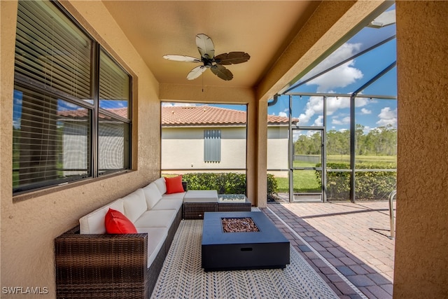 sunroom featuring ceiling fan and plenty of natural light