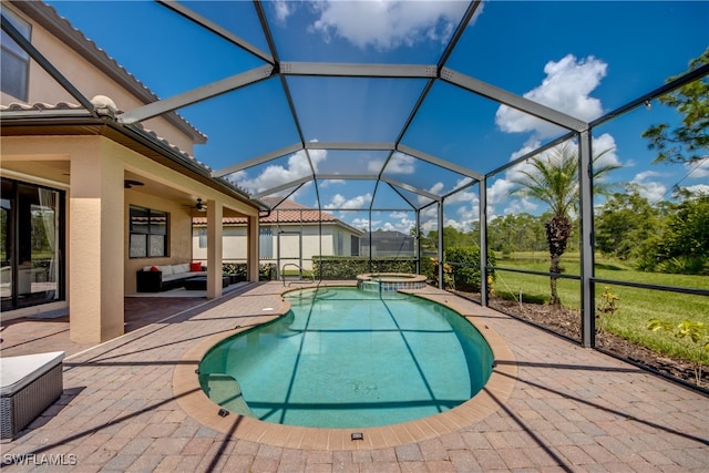 view of swimming pool with a lanai, ceiling fan, outdoor lounge area, and a patio area