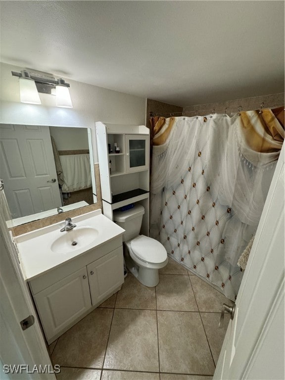 bathroom featuring vanity, a shower with curtain, toilet, and tile patterned flooring