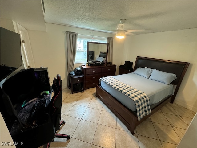 tiled bedroom with a textured ceiling and ceiling fan