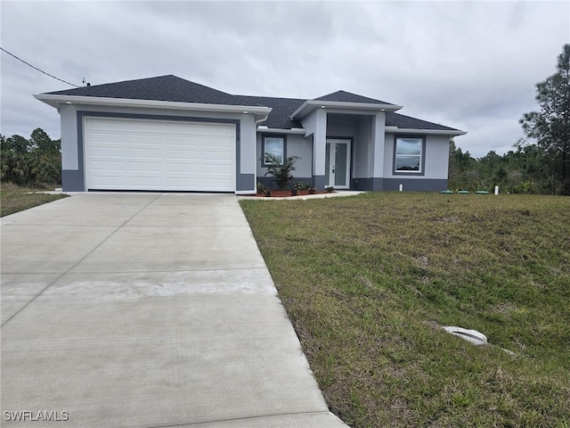 view of front facade with a garage and a front lawn